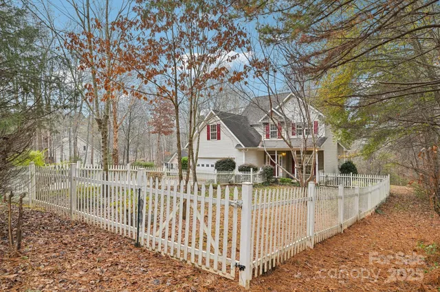 a view of a house with wooden fence