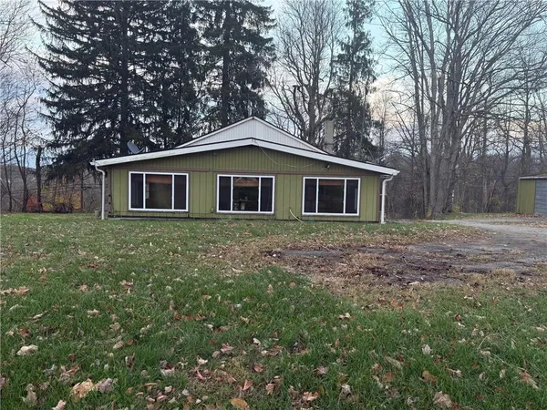 a house that has a tree in front of the house