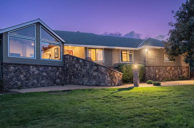 a front view of house with yard and green space