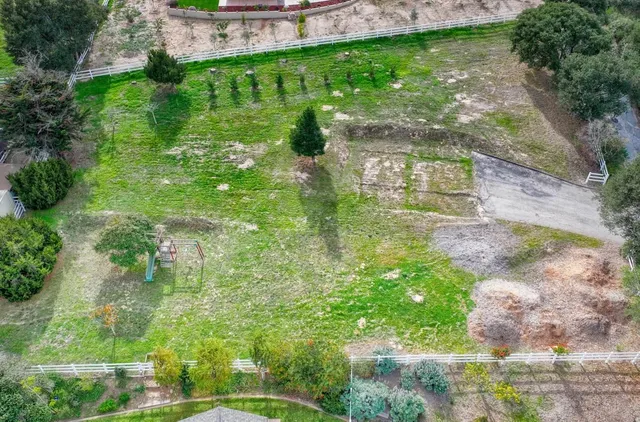 a living room with furniture and large windows