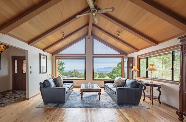 a view of a dining room with furniture a chandelier and wooden floor