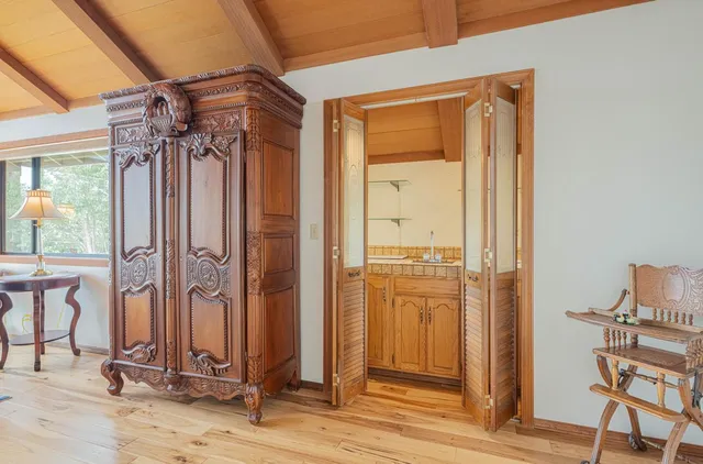 a living room with furniture a wooden floor and next to a window