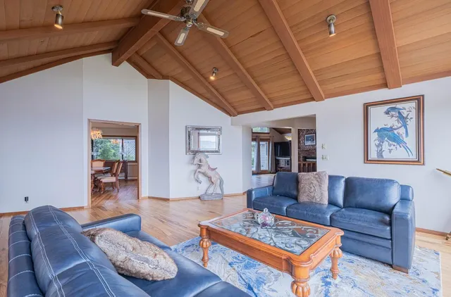 a bed sitting in a spacious bedroom next to a window