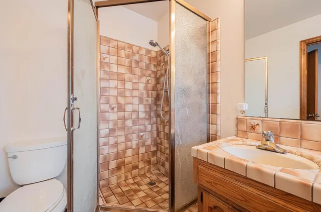 an aerial view of residential house with outdoor space and trees all around