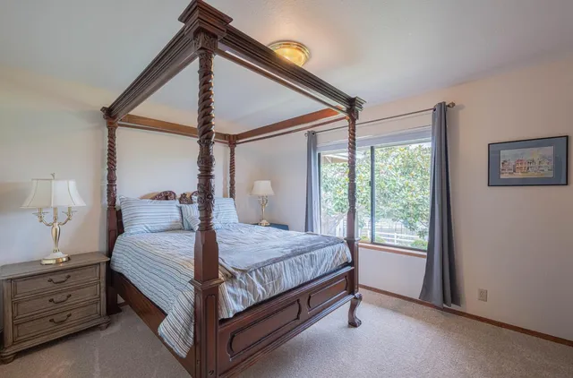 an aerial view of a house with garden space and street view