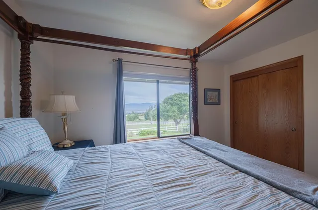 an aerial view of a house with a yard and mountain view in back