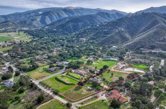 a view of a swimming pool with a yard and mountain view