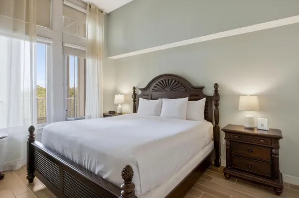 a bedroom with a bed and a painting on the wall