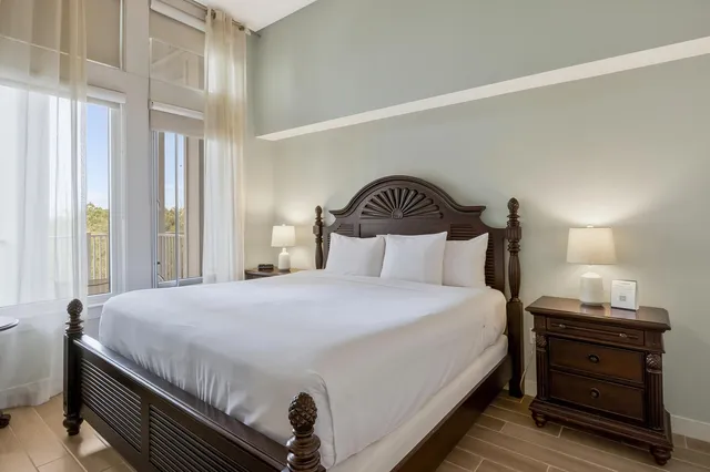 a bedroom with a bed and a painting on the wall