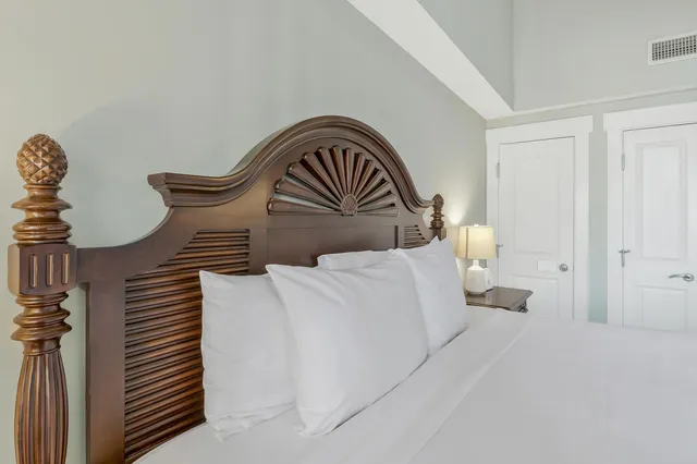 a bedroom with a bed and a flat tv screen on a dresser