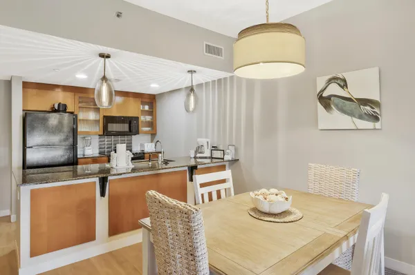 a kitchen with stainless steel appliances granite countertop a sink refrigerator and cabinets