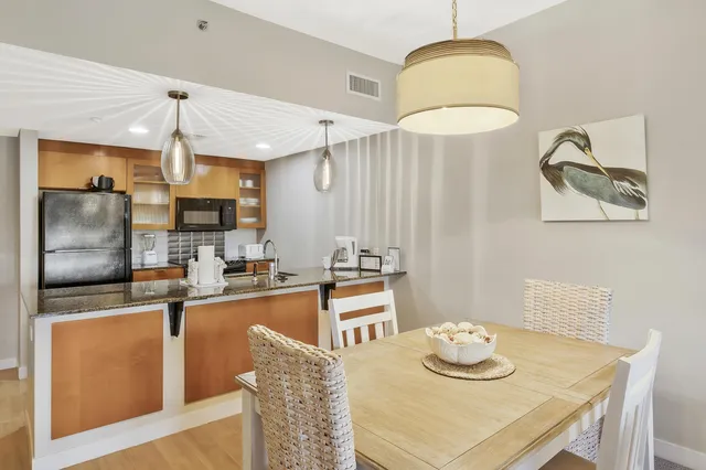 a kitchen with stainless steel appliances granite countertop a sink refrigerator and cabinets
