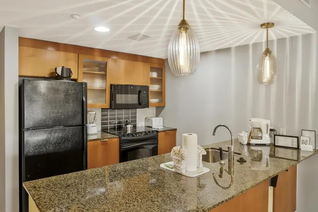 a close view of a sink and a refrigerator in a kitchen