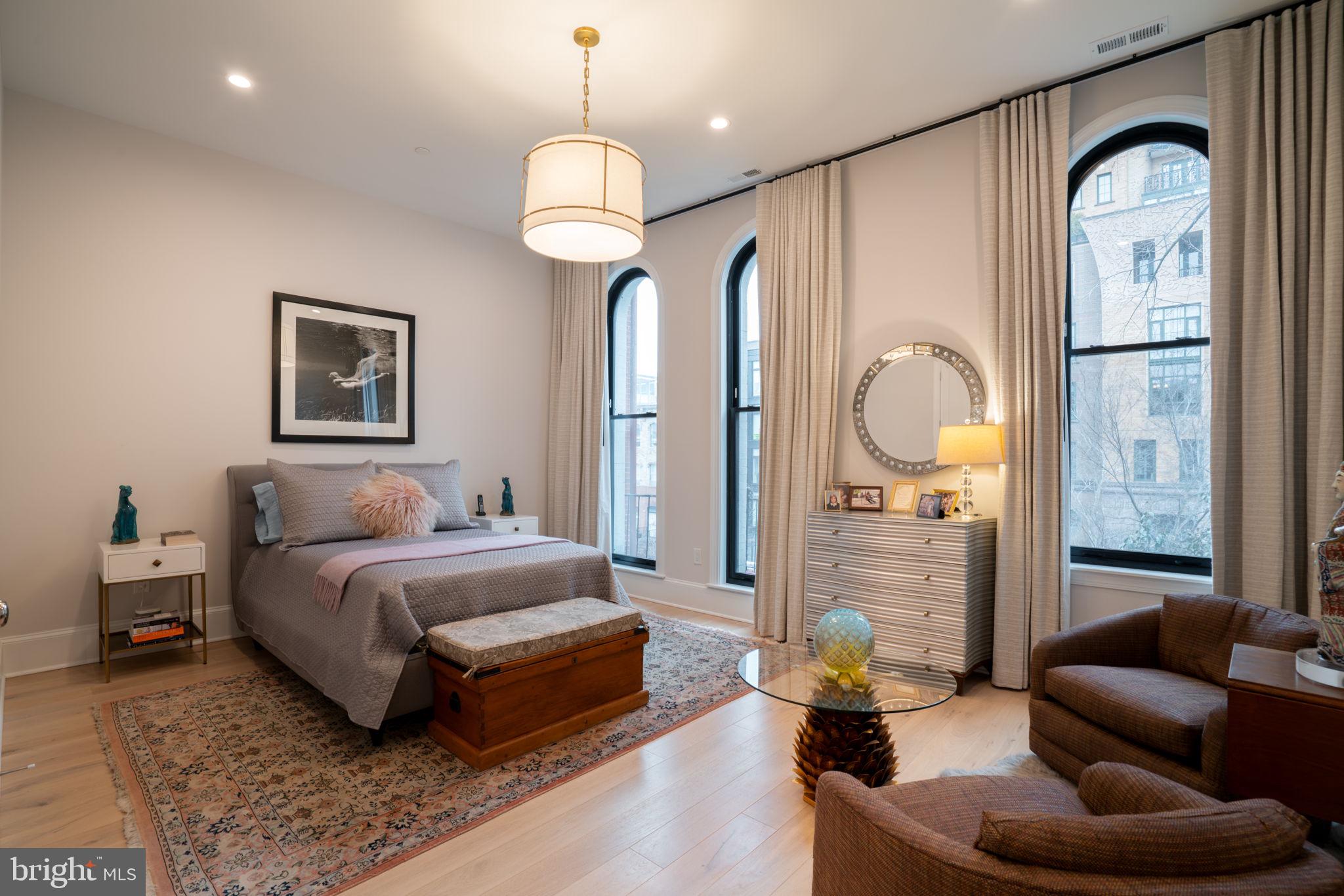 911 M Street Northwest Washington, DC 20001 - Photo 12 of 31 a spacious bedroom with a bed couch and a window