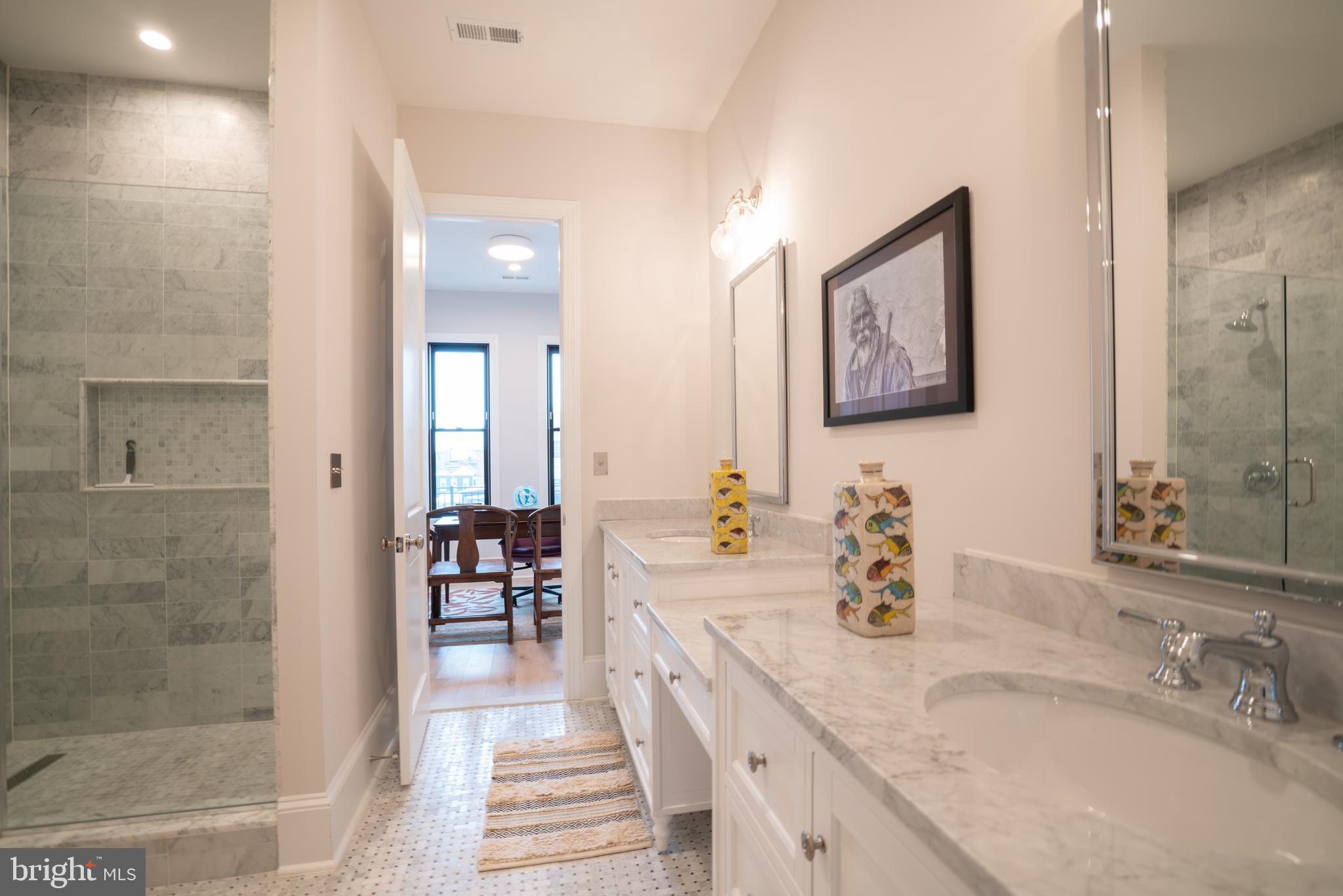 911 M Street Northwest Washington, DC 20001 - Photo 18 of 31 a bathroom with double vanity sinks a shower and a mirror