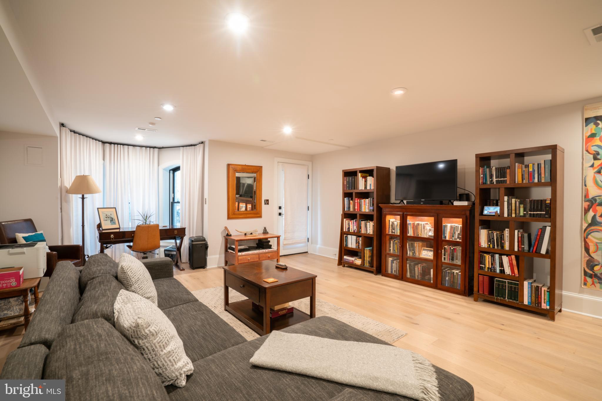 911 M Street Northwest Washington, DC 20001 - Photo 22 of 31 a living room with furniture a bookshelf and a wooden floor
