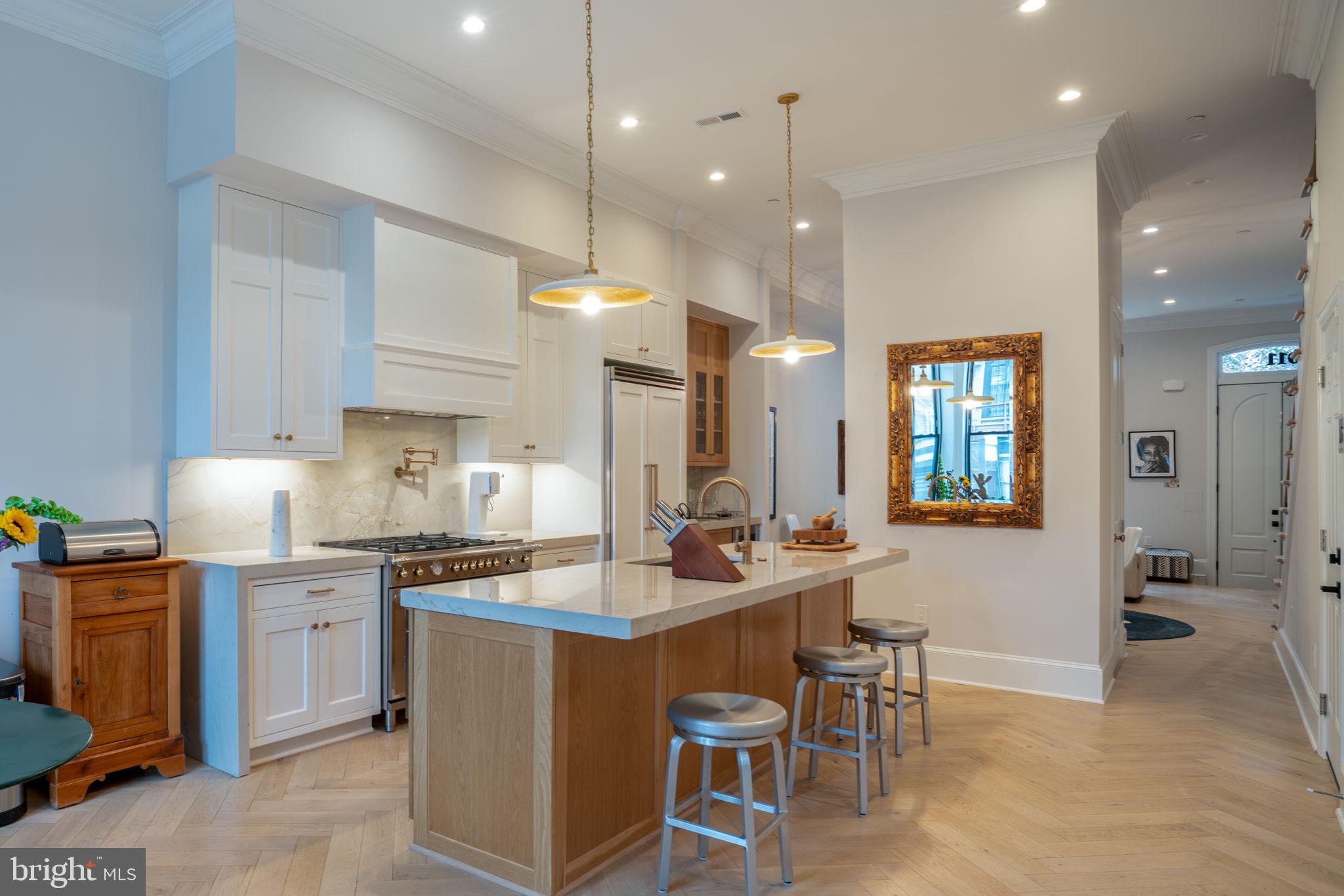 911 M Street Northwest Washington, DC 20001 - Photo 7 of 31 a large kitchen with a counter space a sink stainless steel appliances and cabinets