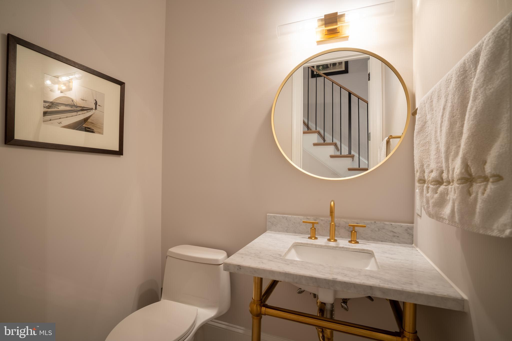 911 M Street Northwest Washington, DC 20001 - Photo 10 of 31 a bathroom with a toilet a sink and a mirror