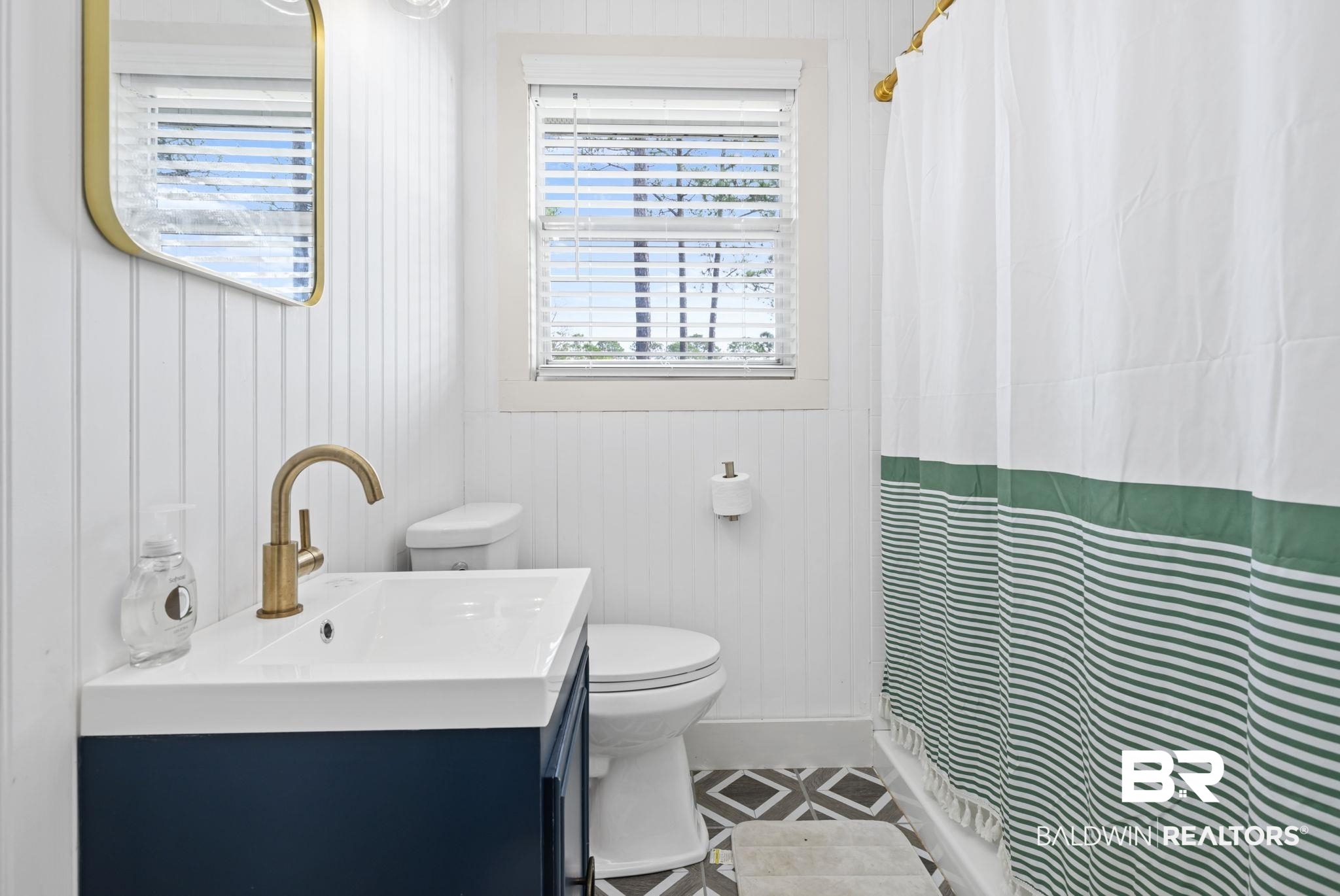 7947 Bayshore Drive Elberta, AL 36530 - Photo 20 of 26 Bathroom with vanity, curtained shower, and wooden walls