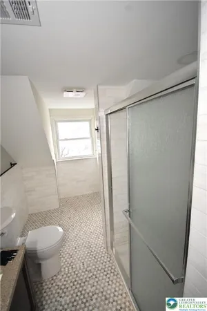 a bathroom with a shower toilet and sink