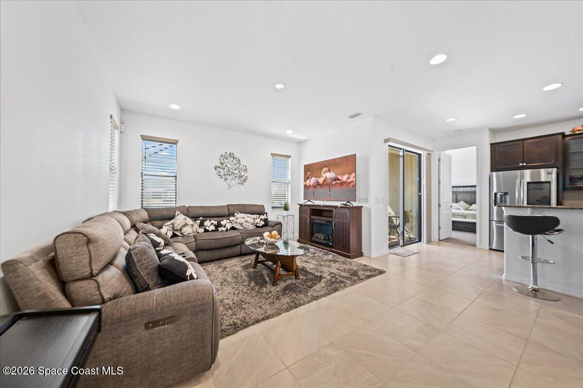3235 Hummingbird Way Melbourne, FL 32940 - Photo 13 of 31 a living room with furniture and a flat screen tv