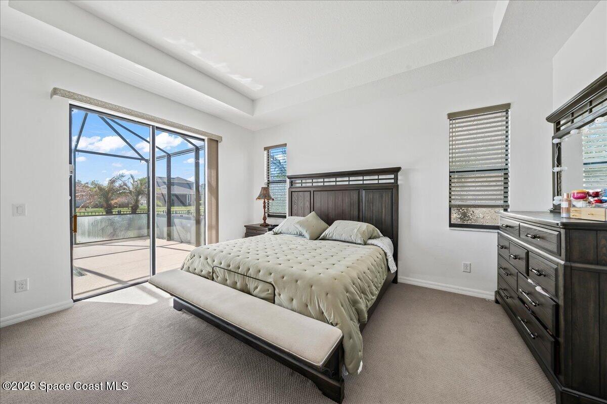 3235 Hummingbird Way Melbourne, FL 32940 - Photo 14 of 31 a bed sitting in a bedroom next to a window