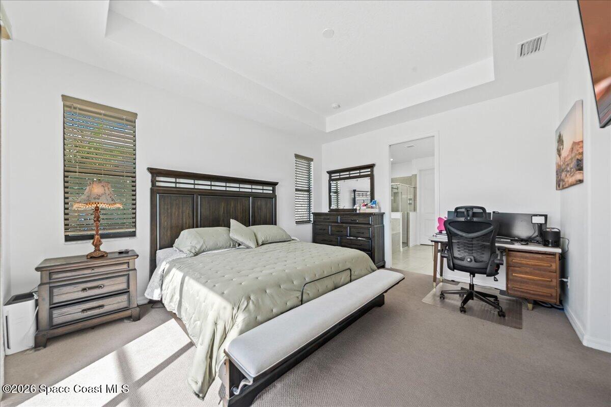 3235 Hummingbird Way Melbourne, FL 32940 - Photo 16 of 31 a bedroom with a bed and furniture