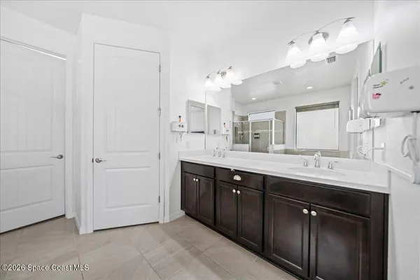 a bathroom with a double vanity sink and a mirror