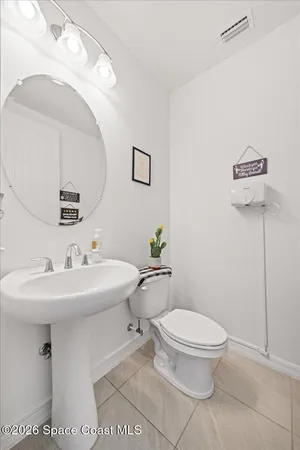 a bathroom with a sink toilet and mirror
