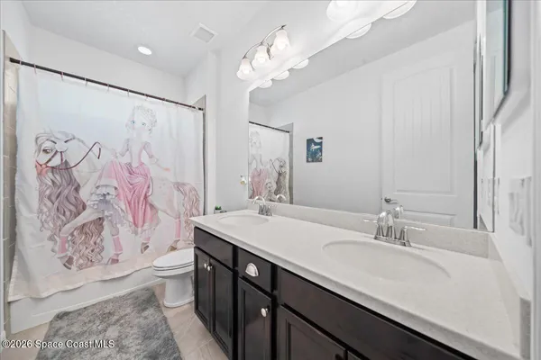 a bathroom with a granite countertop sink a large mirror and shower