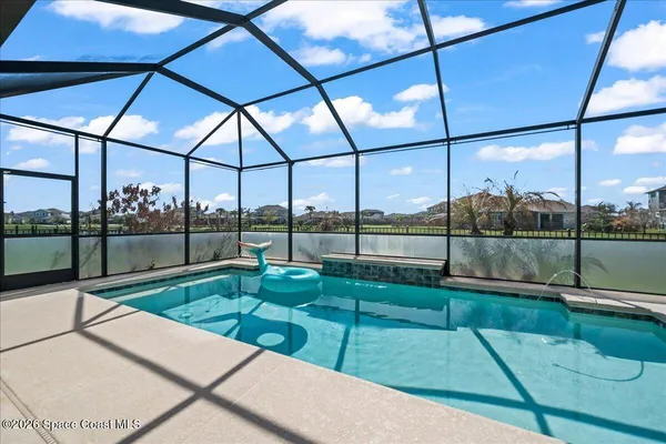a view of a backyard with couches under an umbrella