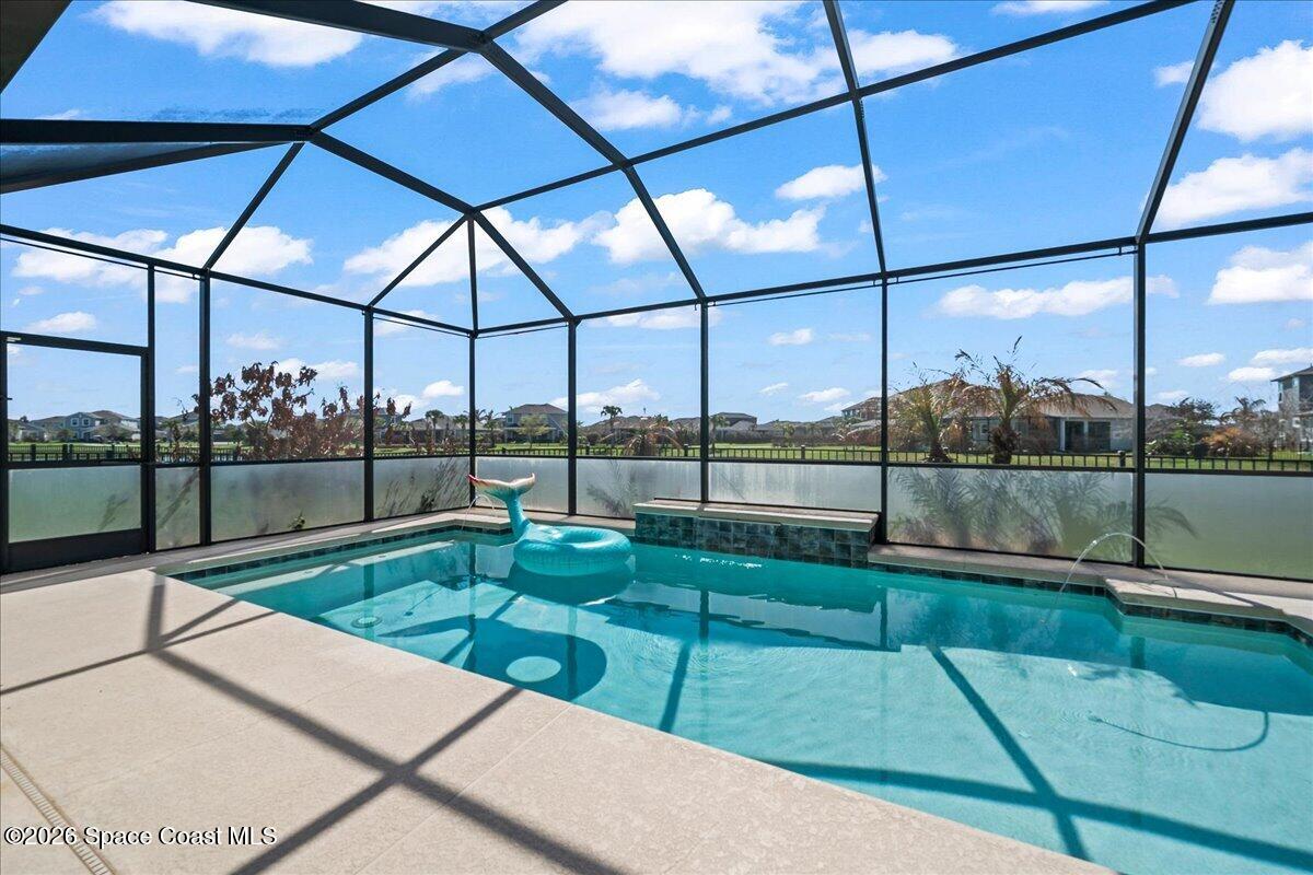 3235 Hummingbird Way Melbourne, FL 32940 - Photo 2 of 31 a view of a backyard with couches under an umbrella