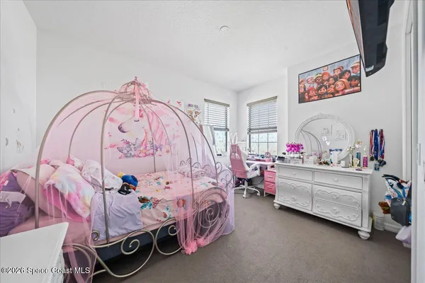 a bedroom with a bed and a white cabinets