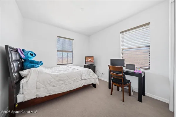 a bedroom with a bed and a desk