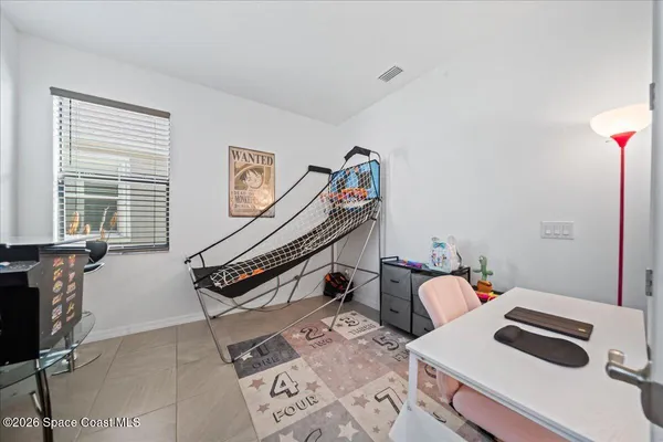 a bedroom with furniture and a window