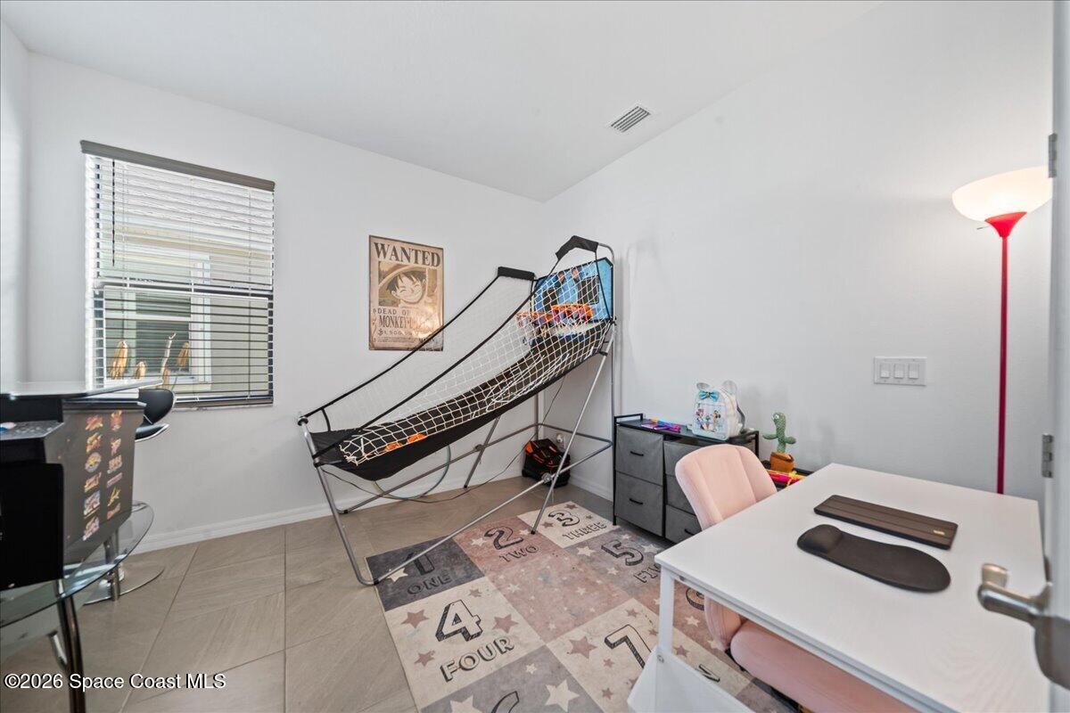 3235 Hummingbird Way Melbourne, FL 32940 - Photo 23 of 31 a bedroom with furniture and a window