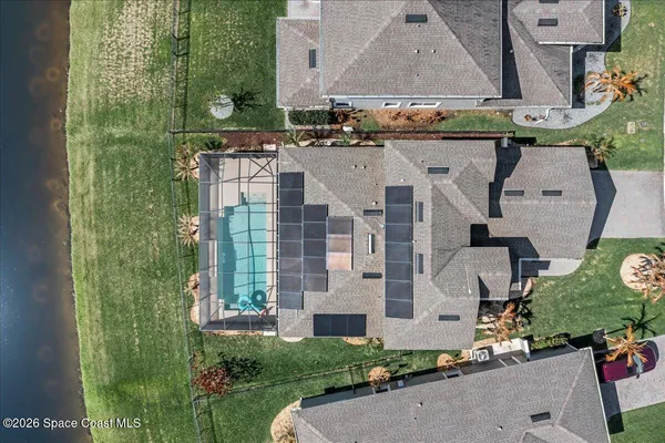 an aerial view of residential houses with outdoor space and street view
