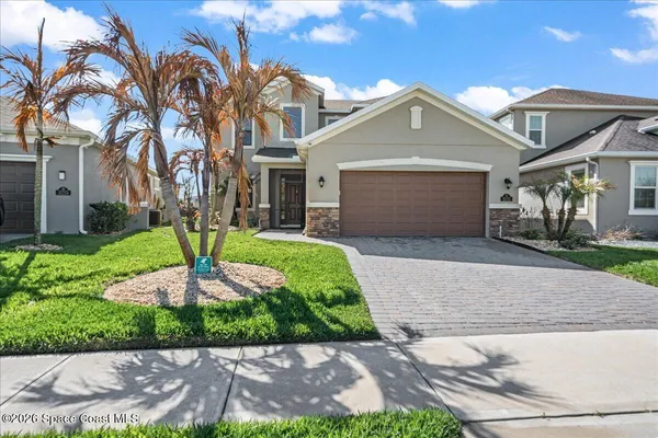 a front view of a house with a yard and garage