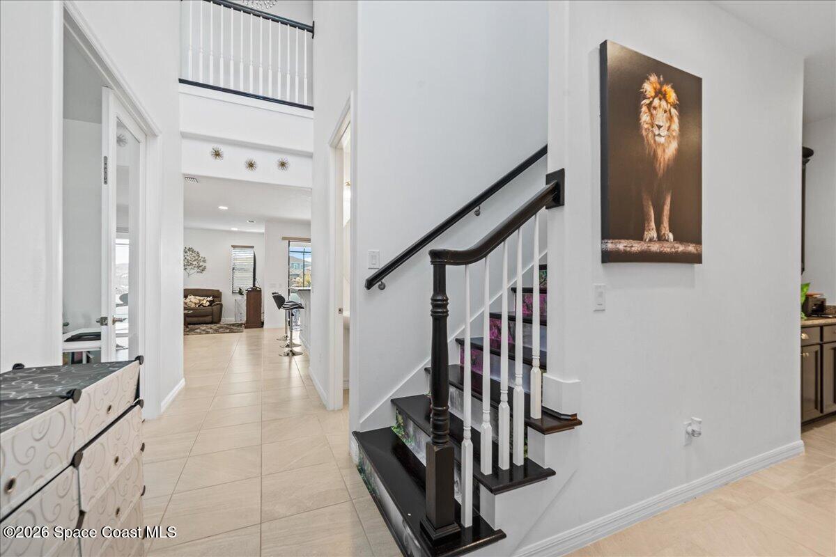3235 Hummingbird Way Melbourne, FL 32940 - Photo 7 of 31 a view of a hallway with entryway and hall with wooden floor