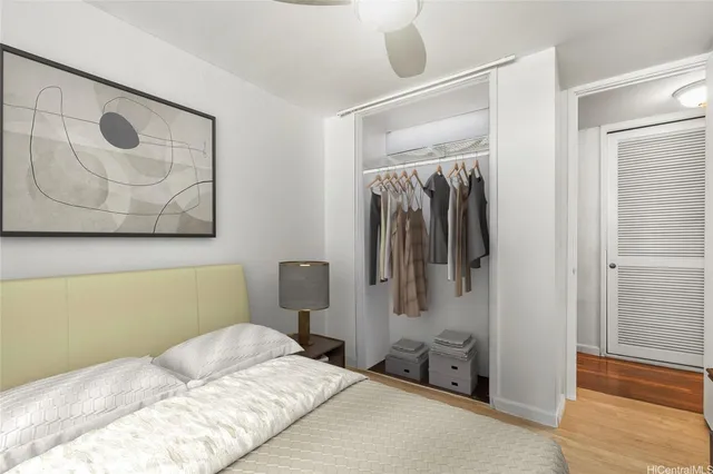 a bedroom with a bed and a painting on the wall