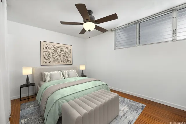 a bed room with a bed and a ceiling fan