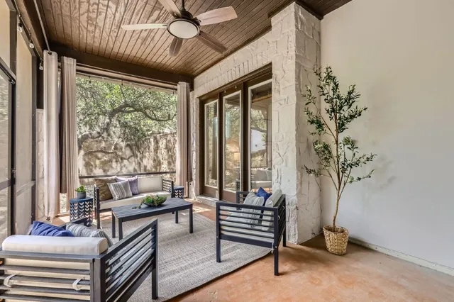 a living room with furniture and a potted plant
