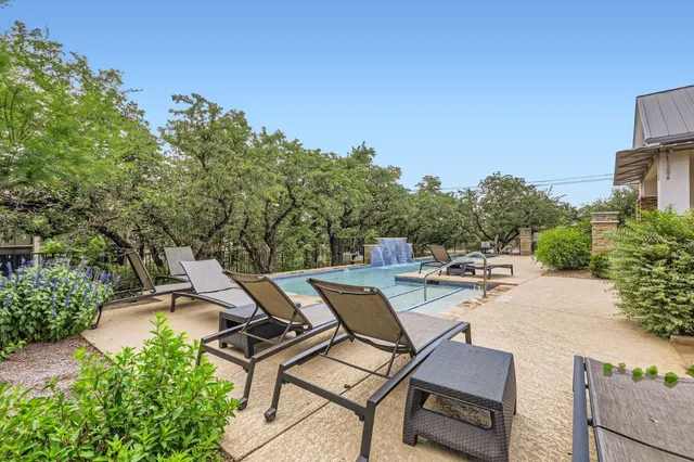 a view of a patio with table and chairs and potted plants
