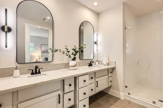 a bathroom with a double vanity sink mirror and double