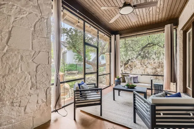 a living room with large windows with wooden floor