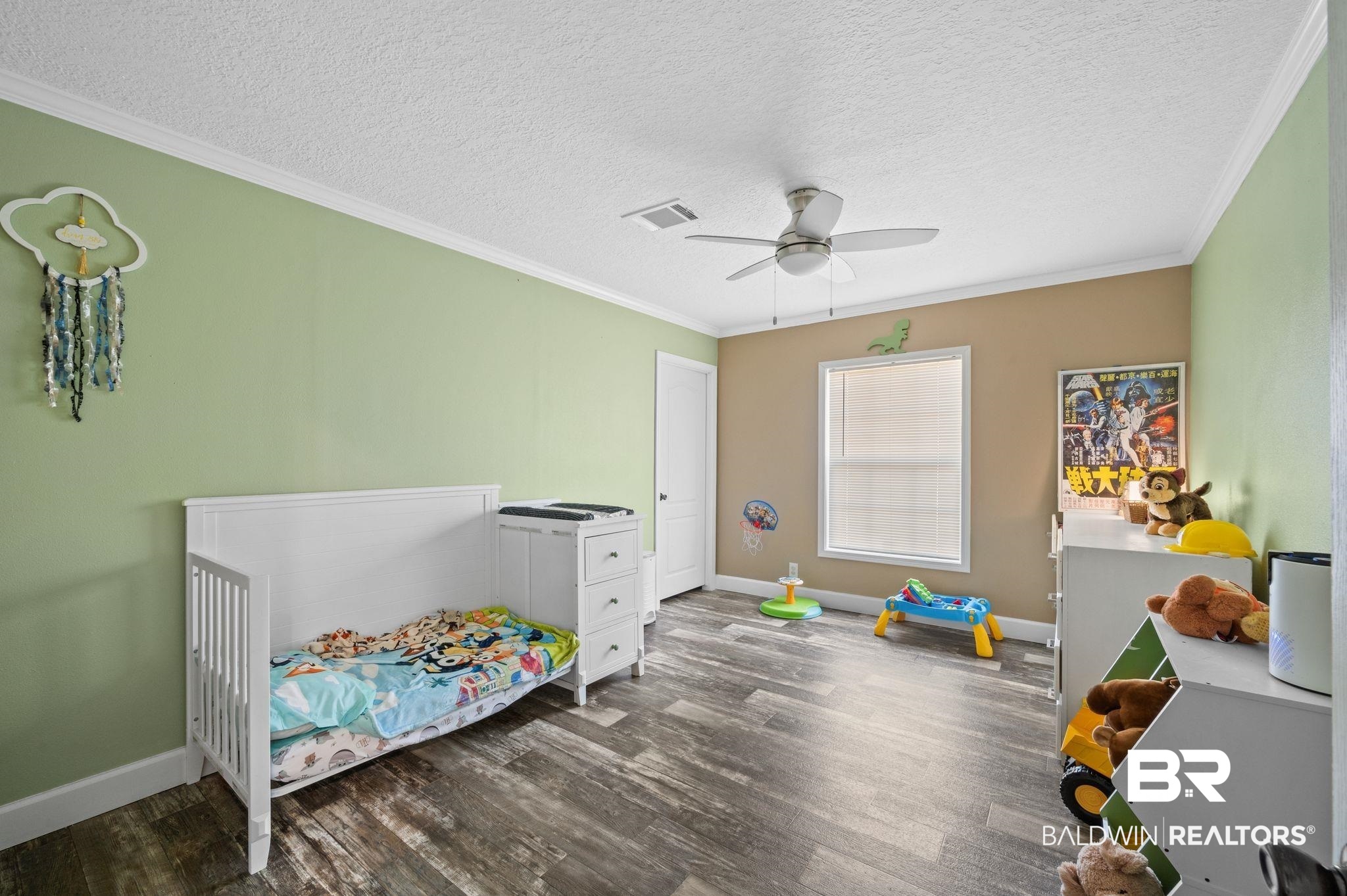 9382 D'Olive Street Bay Minette, AL 36507 - Photo 12 of 27 Playroom featuring a textured ceiling, crown molding, ceiling fan, and dark hardwood / wood-style floors