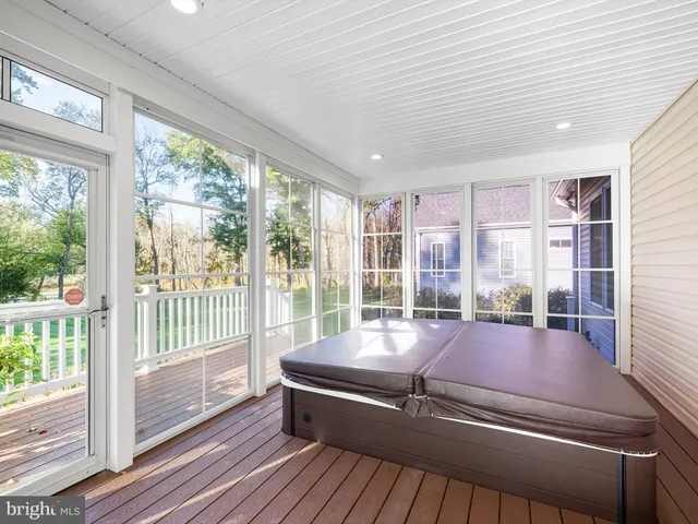 a room with pool table and windows