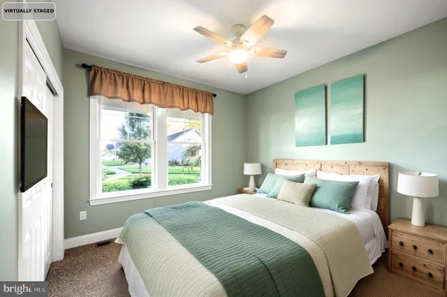 a bedroom with a large bed and a large window