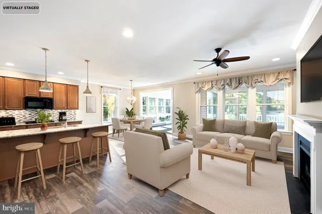 a living room with furniture a flat screen tv and a large window