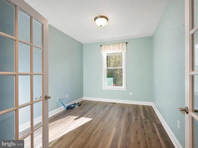 a view of a room with wooden floor and windows